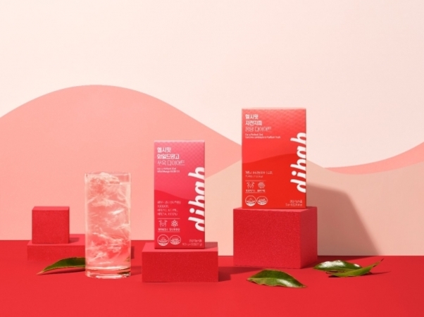 분홍색과 빨간색 톤의 배경 위에 dibah 브랜드의 음료 박스 두 개와 얼음이 담긴 유리잔이 전시되어 있고, 주변에 녹색 잎들이 놓여 있다.