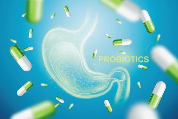 푸른 배경에 투명한 위 그림과 함께 초록색과 흰색의 캡슐 약들이 떠 있고, 'PROBIOTICS'라는 글자가 보인다.